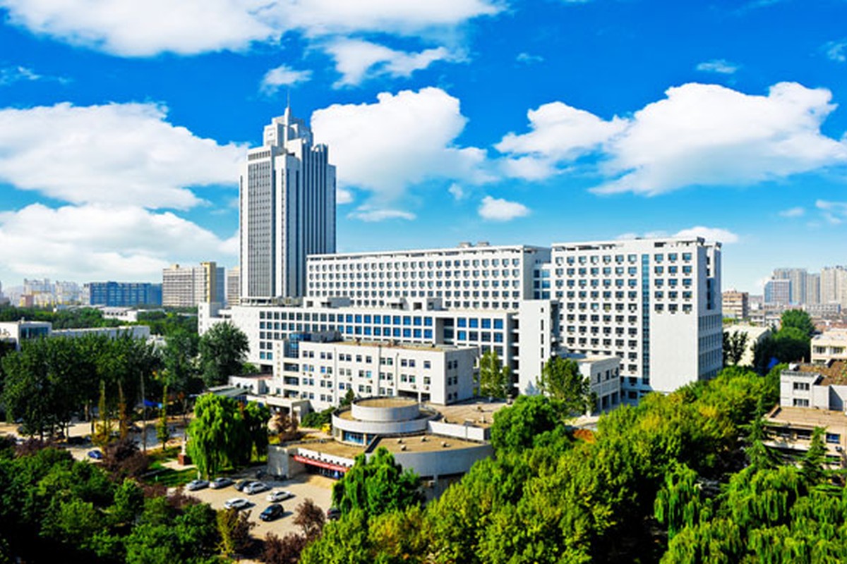 A bright modern building beneath a clear blue sky.
